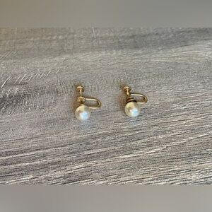 Vintage women’s stamped metal, gold color, and faux pearl earrings